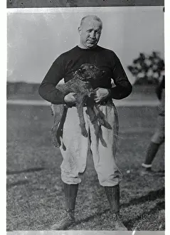 Notre Dame Coach Knute Rockne Holding Dog