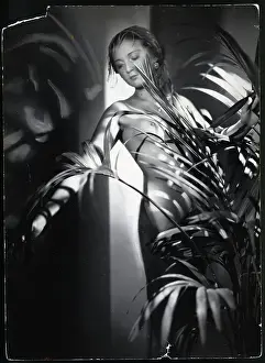 Nude Woman Standing Behind Plant/Inside