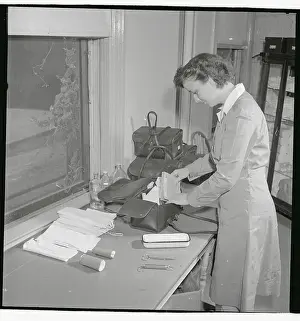 Nurse Checking Contents of Her Bag
