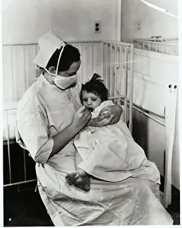 Nurse Feeding Child with Sleeping Sickness