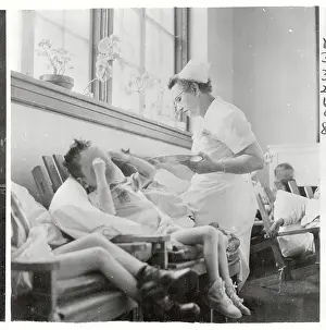 Nurse Feeding a Retarded Village Children