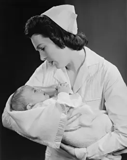 30 35 Years Prints: Nurse holding crying baby (B&W)