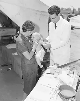 Visalia Prints: Nurse Holding Migrant Baby for Doctor