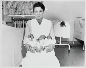 Nurse Holding Triplets