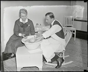 Fatherhood Prints: Nurse Instructing Father on Bathing His Baby