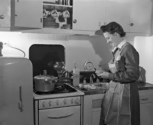 Nurse in Kitchen Peeling Potatoes