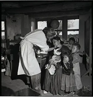 Nurse Treating Mother And Children