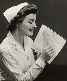 Nurse w patients medical chart