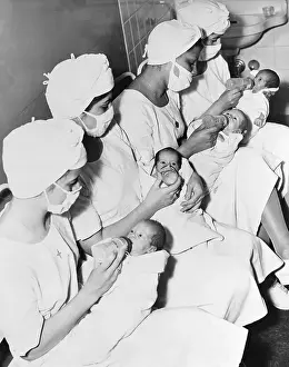 Nurses Feeding Quadruplets