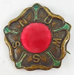 Prints of Red, green, and gold, enamel and metal pin or badge, with a stylized rose and the acronym NUWSS, issued by the National Union of Women Suffrage Societies (NUWSS), for the British market, 1900 Historic Moments from the Women’s Fight for the Vote: NUWSS Suffrage Pin