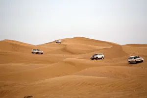 Off-road Vehicles Navigating Down a Sand Dune. Hatta, United Arab Emirates Off-road Vehicles Navigating Down a Sand Dune. Hatta, United Arab Emirates