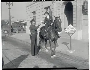 Officer Handing Frances Drake Ticket