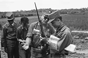 Officers Examining Weapon in Vietnam