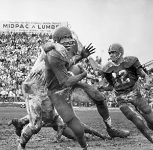 Simpson Prints: O.J. Simpson Tackled on Muddy Field