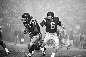 Simpson Prints: O.J. Simpson Takes Football from Steve Sogge