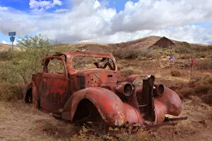 Wild West Gallery: Old car rusting in Desert Landscape