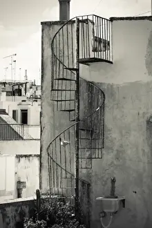 Risk Prints: Old cast iron spiral staircase accessing a rooftop terrace in Otranto, Apulia, Italy