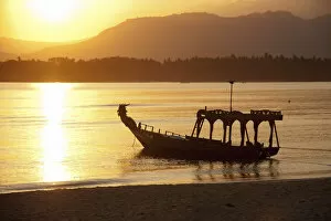 Old fishing boat on the beach, at sunrise, near Pemenang, Lombok, Indonesia