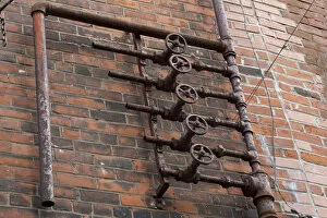 Line Gallery: Old pipes on brick wall, Montreal, Quebec, Canada