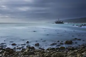 Rust Prints: Old shipwreck long exposure on the rocks at sunset - Cape LAgulhas South Africa