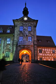 Old Town Hall at dusk, built from 1461-1467 in its present form in the Regnitz River, Obere Bruecke bridge at the front