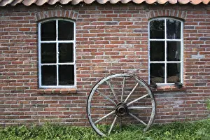 Bricks Prints: Old wagon wheel on a facade, brick stone, East Frisia, Lower Saxony, Germany, Europe