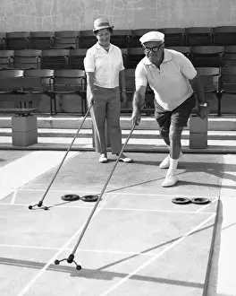 Older couple playing shuffleboard