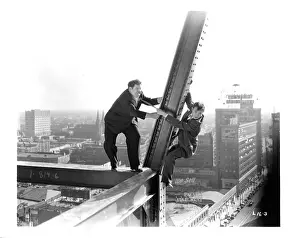 Prints of Oliver Hardy and Stan Laurel hang off a beam in a scene from the film Liberty, 1929. (Photo by Metro-Goldwyn-Mayer/Getty Images) Timeless Comedy Icons: Classic Moments from the Legendary Duo: Oliver Hardy And Stan Laurel In Liberty