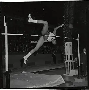 Olympian John Thomas Jumping Over High Bar