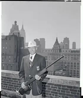 Olympic Shooting Team Member Holding Rifle
