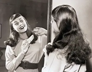 Opera singer Roberta Peters Combing Hair in Mirror