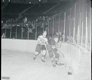 Opponents Competing for Hockey Puck