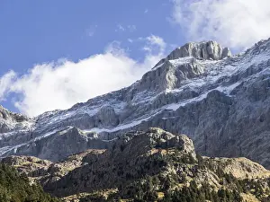 Crag Prints: ops of big rocky covered with snow mountains in autumn a day of blue sky