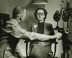 40 49 Years Prints: Optician examining patients eyes, (B&W)