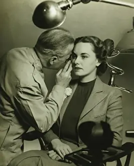 50 59 Years Prints: Optician examining womans eye, (B&W)
