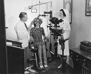 Optometrist examining womans eyes (B&W)