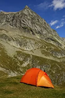 Pinnacle Collection: Orange-coloured mountain tent below the summit of Wiwanni Mountain in the Pennine Alps, Valais