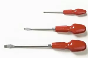 Three orange handled slot-headed screwdrivers