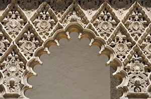 Ornate decorated arch of the Seville Alcazar in Spain