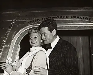 Orson Welles and Rita Hayworth Posing at Airplane Doorway