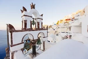 Images Dated 25th August 2012: Orthodox church and its bell tower in Oia village, Santorini, Cyclades, Greece