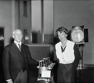 Orville Wright and Amelia Earhart Putnam Standing Near Airplane Parts