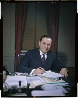 Oscar L. Chapman Sitting at Desk