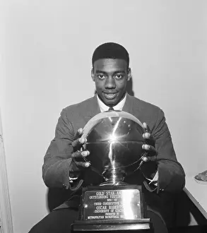 Oscar Robertson Holding Trophy