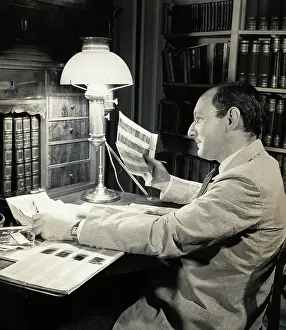 Founder Prints: Otto Bettmann Examining Negatives