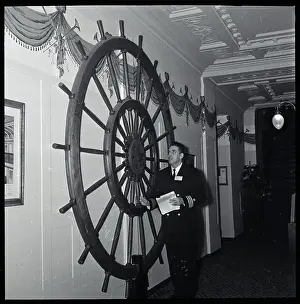 Otto Graham Admiring Ship Wheel on Wall