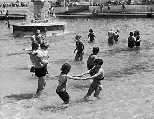 Prints of Children and adults enjoy an outdoor bathing pool in Plymouth, on the south coast of England, 19th July 1941. Original Publication : Picture Post - 801 - In Plymouth Life Goes On - pub Discover the Vision of Haywood Magee – A Master of Mid-Century British Life: Outdoor Pool