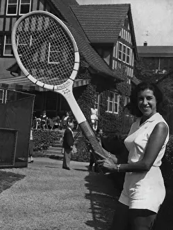 Prints of A woman holding a giant Pancho Gonzales tennis racket by Spalding, circa 1955. (Photo by Max Peter Haas/Archive Photos/Getty Images) The Grand Slam Gallery: Outsize Tennis Racket