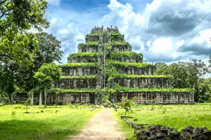 Overgrown stone temple in remote field, Srayong Cheung, Preah Vihear, Cambodia