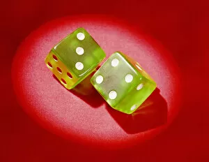 Pair of green plastic dice, showing lucky 7 . (Photo by H